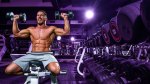 Fit man working out in the gym using a dumbbell shoulder press exercise