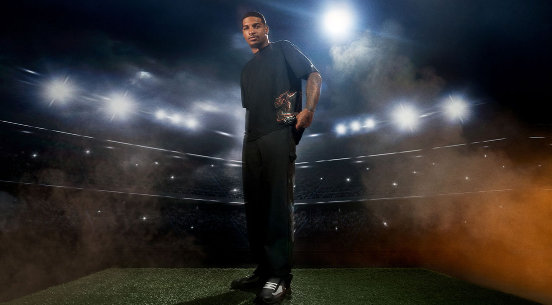 NFL player Ja’Marr Chase standing in the stadium wearing his new fashion line from Fabletics