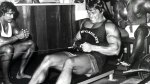 Arnold Schwarzeneggar working out his arms and back with a cable pull exercise